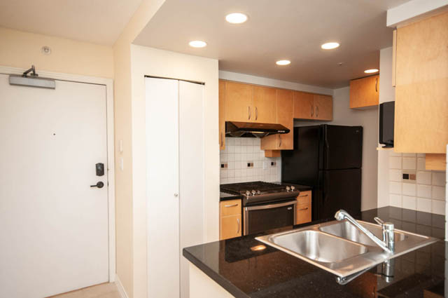 Bright kitchen with black appliances and granite countertops. - 1105 - 198 Aquarius Mews, Vancouver Downtown