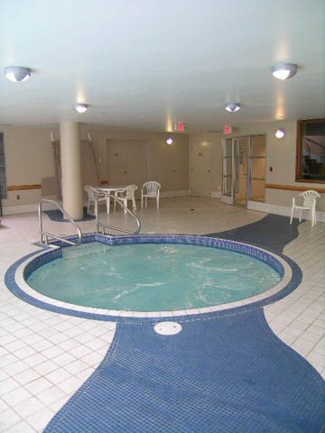 Spacious living room with large windows and a cozy fireplace. - 1105 - 198 Aquarius Mews, Vancouver Downtown