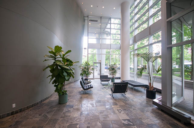 Furnished living room with large windows, modern decor, and a cozy corner. - 1105 - 198 Aquarius Mews, Vancouver Downtown