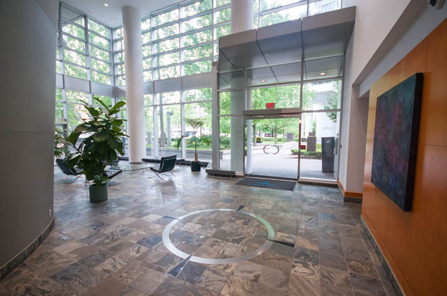 Furnished living room with large windows, marble flooring, and modern decor. - 1105 - 198 Aquarius Mews, Vancouver Downtown