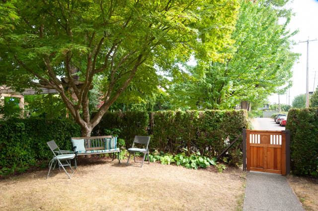 Furnished patio with swing chair and lush greenery. - 2077 W 13th Ave, Vancouver West Side