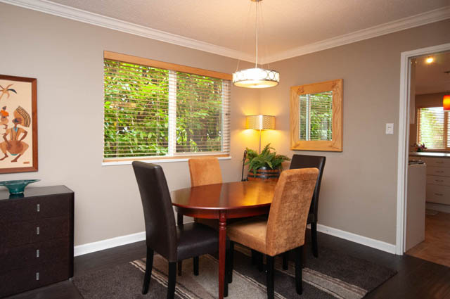 Furnished dining area with hardwood floors and a view of greenery outside. - 2077 W 13th Ave, Vancouver West Side