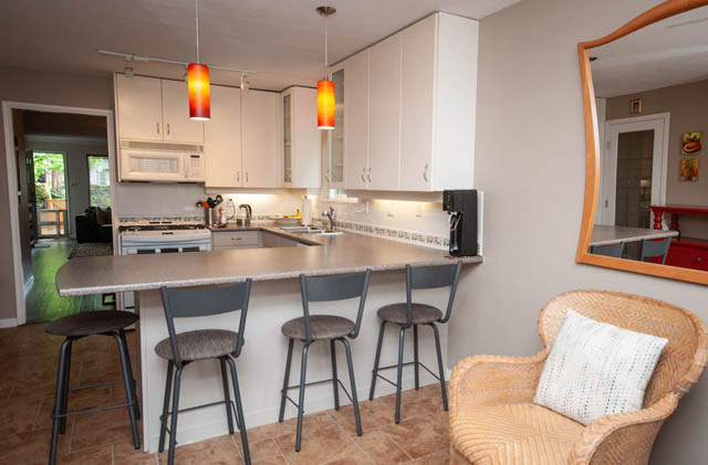 Bright kitchen with granite countertops, modern pendant lights, and a city view. - 2077 W 13th Ave, Vancouver West Side
