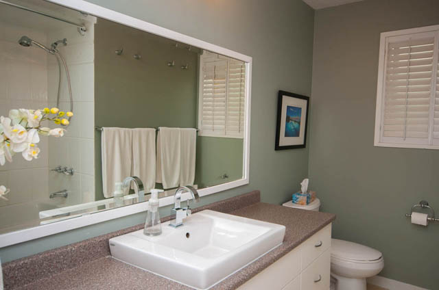 Bright bathroom with granite countertops and a large mirror. - 2077 W 13th Ave, Vancouver West Side