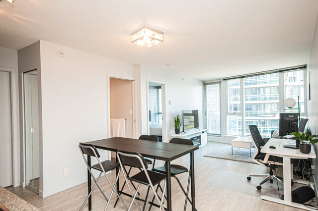 Spacious open-concept living area with hardwood floors, modern furnishings, and a city view. - 1601 - 788 Hamilton Street, Vancouver Downtown