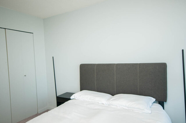 Spacious bedroom with a modern bed and sleek wardrobe. - 1601 - 788 Hamilton Street, Vancouver Downtown