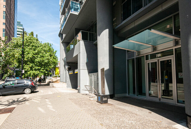 Furnished 1-bedroom condo with modern glass awning and sleek black exterior. - 1601 - 788 Hamilton Street, Vancouver Downtown
