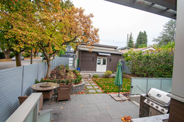 Furnished patio with modern grill, cozy seating, and autumn foliage. - 4504 West 12th Ave, Vancouver West Side