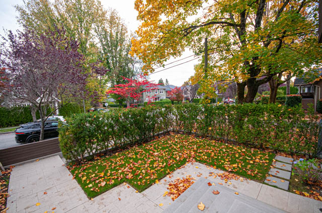 Furnished 4-bedroom + den house with a cozy front yard featuring a neatly trimmed hedge and autumn leaves. - 4504 West 12th Ave, Vancouver West Side