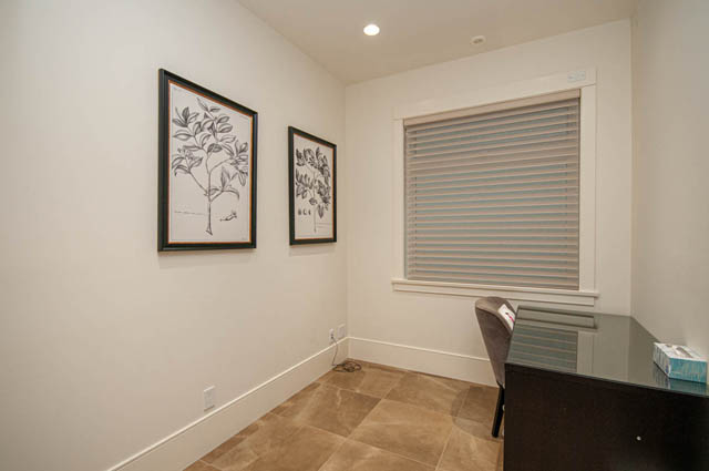 Bright sunroom with tiled floor, framed botanical prints, and sliding glass door. - 4504 West 12th Ave, Vancouver West Side