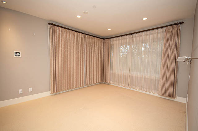 Spacious living room with elegant curtains and recessed lighting. - 4504 West 12th Ave, Vancouver West Side