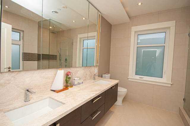 Spacious bathroom with marble countertops and large windows. - 4504 West 12th Ave, Vancouver West Side
