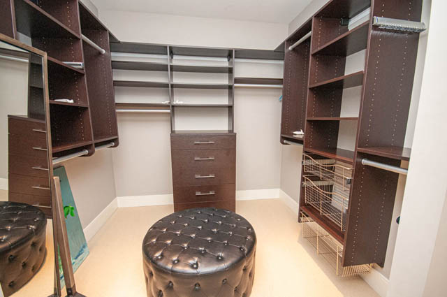Spacious walk-in closet with built-in shelves and drawers, perfect for storage. - 4504 West 12th Ave, Vancouver West Side