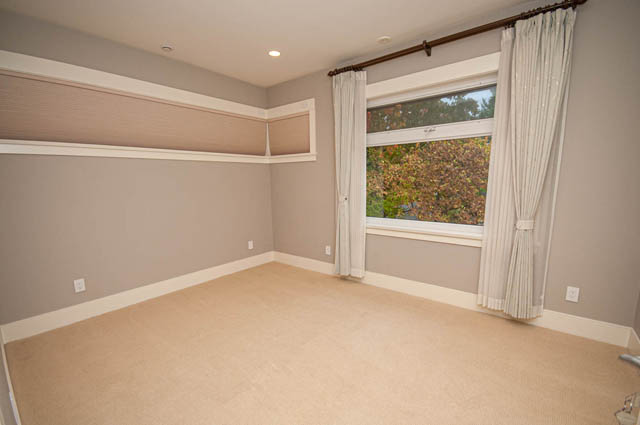 Spacious den with built-in shelving and a view of autumn foliage. - 4504 West 12th Ave, Vancouver West Side