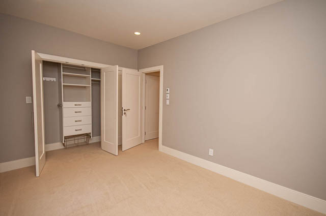 Spacious den with built-in closet and carpeted floor, perfect for a cozy workspace or relaxation area. - 4504 West 12th Ave, Vancouver West Side
