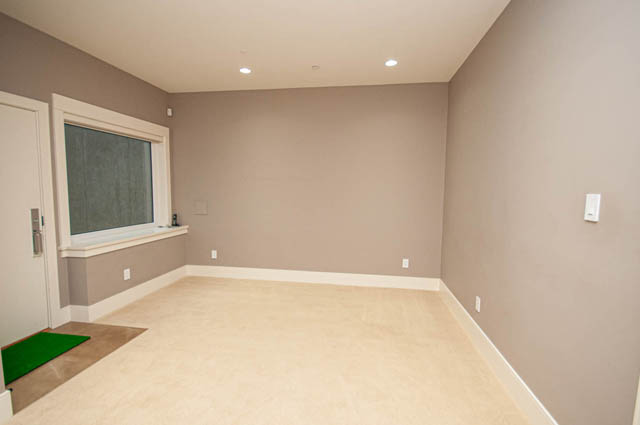 Spacious den with built-in bench seating and recessed lighting. - 4504 West 12th Ave, Vancouver West Side