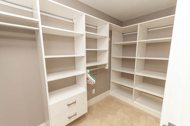 Spacious walk-in closet with ample shelving and drawers, perfect for organization. - 4504 West 12th Ave, Vancouver West Side