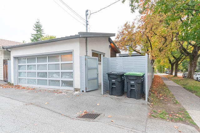 Modern garage with frosted glass doors and a sleek, contemporary design. - 4504 West 12th Ave, Vancouver West Side