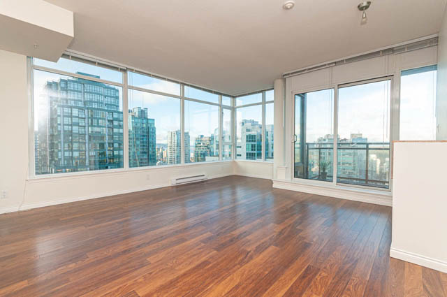 Bright living room with hardwood floors, large windows, and city view. - 3102 - 1211 Melville Street, Vancouver Downtown