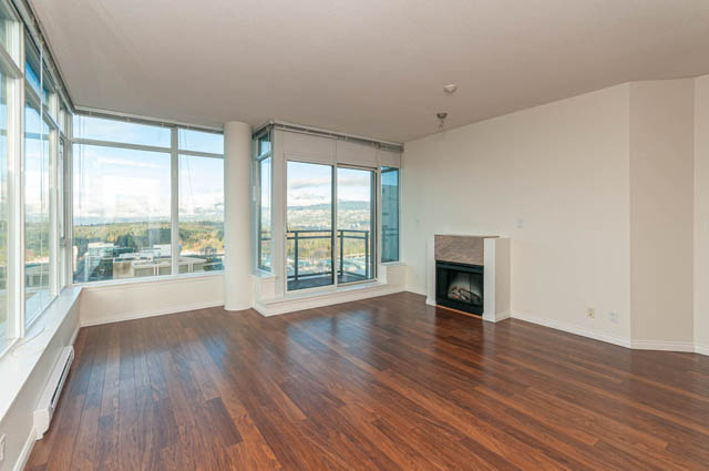 Bright living room with hardwood floors, city view, and fireplace. - 3102 - 1211 Melville Street, Vancouver Downtown