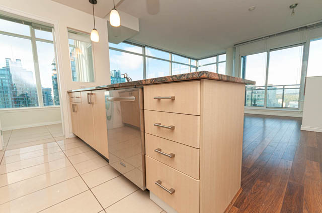 Bright kitchen with granite countertops and hardwood floors, offering a city view. - 3102 - 1211 Melville Street, Vancouver Downtown