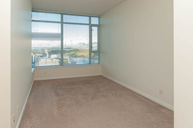 Den with large windows offering a city view and carpeted floor. - 3102 - 1211 Melville Street, Vancouver Downtown