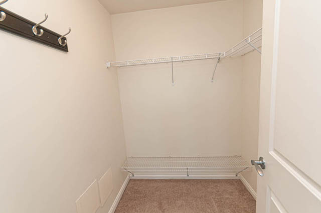 Bright walk-in closet with hanging rod and shelving. - 3102 - 1211 Melville Street, Vancouver Downtown