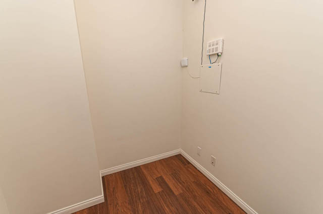 Den area with hardwood floors and electrical panel. - 3102 - 1211 Melville Street, Vancouver Downtown
