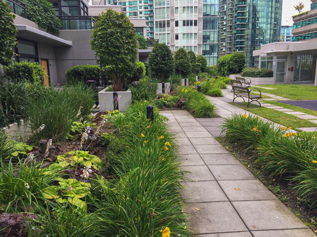 Furnished patio with lush greenery and city view. - 3102 - 1211 Melville Street, Vancouver Downtown