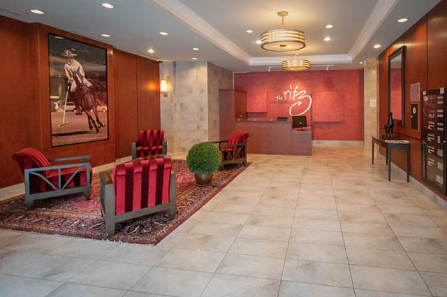 Furnished living room with red chairs and artwork, modern decor. - 3102 - 1211 Melville Street, Vancouver Downtown