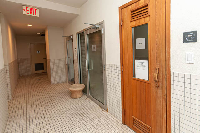Furnished hallway with tiled floors and wooden doors leading to a sauna. - 3102 - 1211 Melville Street, Vancouver Downtown