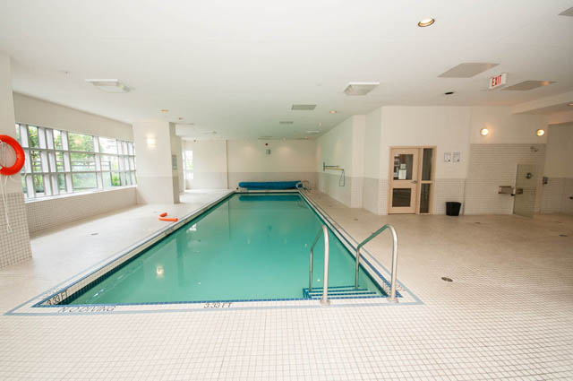 Spacious indoor pool with tiled floors and large windows. - 3102 - 1211 Melville Street, Vancouver Downtown