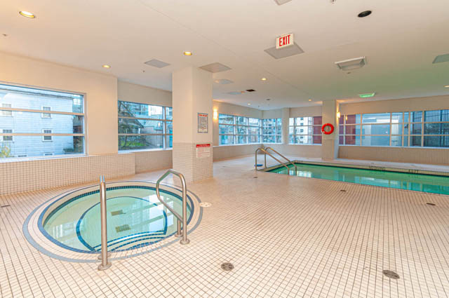 Spacious, well-lit indoor pool area with tiled floors and city views. - 3102 - 1211 Melville Street, Vancouver Downtown
