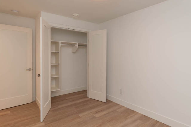 Spacious walk-in closet with built-in shelves and hardwood floors. - Suite - 778 Crystal Court, North Vancouver