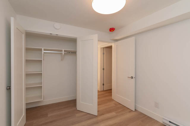 Spacious walk-in closet with built-in shelves and hardwood floors. - Suite - 778 Crystal Court, North Vancouver