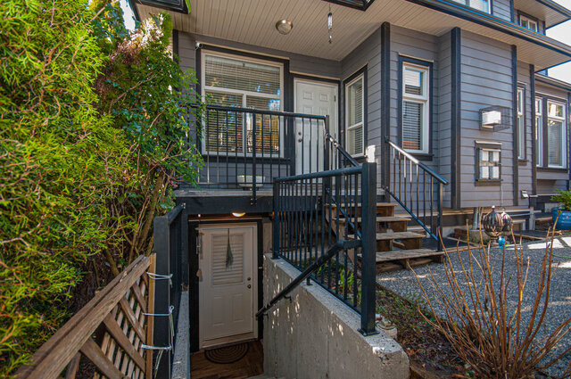 Private entryway with concrete steps and black railings surrounded by greenery. - Suite - 1534 Bewicke Avenue, North Vancouver