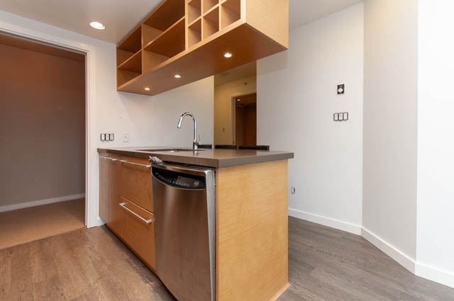 Bright kitchen with modern wood cabinetry and stainless steel appliances. - 1102-833 Seymour Street, Vancouver Downtown