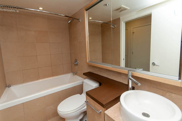 Furnished bathroom with beige tiles and modern fixtures. - 1102-833 Seymour Street, Vancouver Downtown