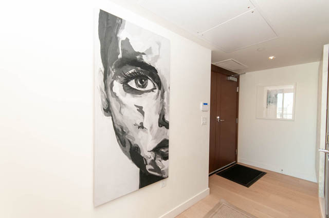 Bright hallway with large black-and-white portrait and wooden flooring. - 2818  - 89 Nelson Street, Vancouver Downtown
