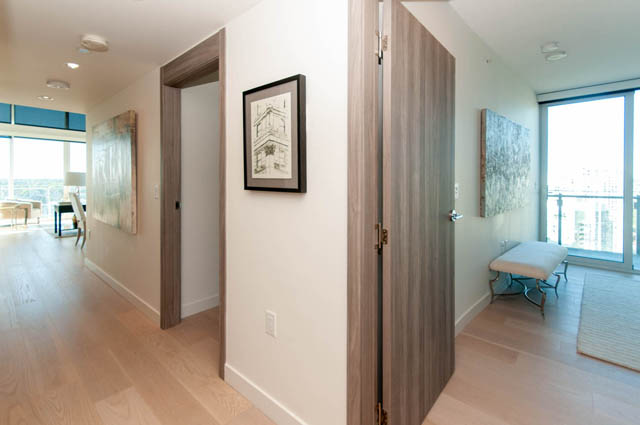 Spacious hallway with hardwood floors, city view, and modern artwork. - 2818  - 89 Nelson Street, Vancouver Downtown