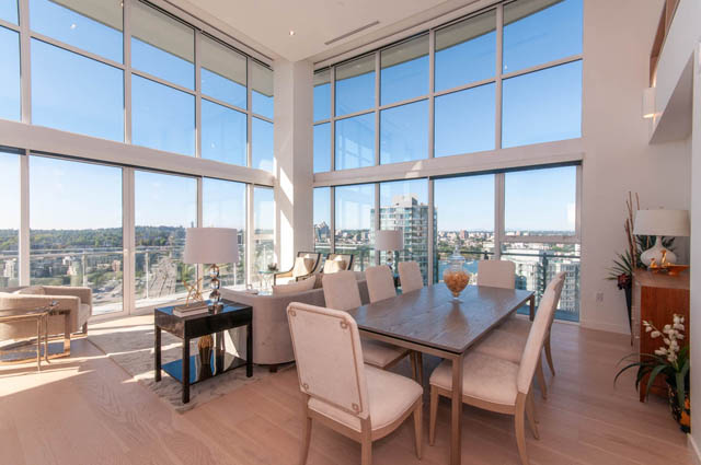 Spacious penthouse living room with hardwood floors, large windows, and a stunning city view. - 2818  - 89 Nelson Street, Vancouver Downtown