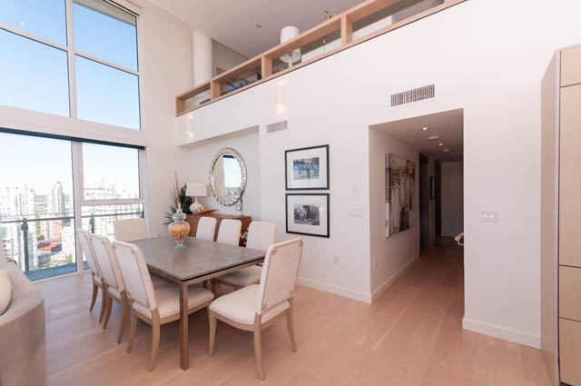 Spacious penthouse dining area with hardwood floors, large windows, and a city view. - 2818  - 89 Nelson Street, Vancouver Downtown