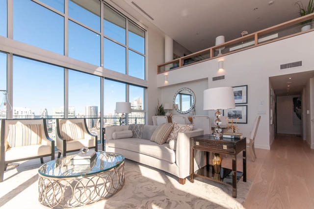 Spacious penthouse living room with floor-to-ceiling windows and modern furnishings. - 2818  - 89 Nelson Street, Vancouver Downtown