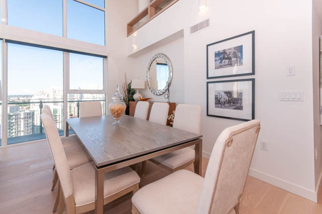 Spacious dining room with hardwood floors, large windows, and a city view. - 2818  - 89 Nelson Street, Vancouver Downtown