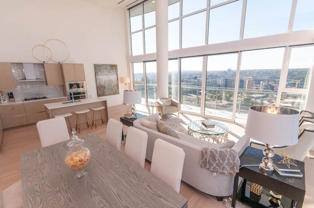 Spacious penthouse living room with hardwood floors, a large city view, and modern furnishings. - 2818  - 89 Nelson Street, Vancouver Downtown