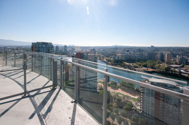 Penthouse balcony with glass railings offers stunning city and river views. - 2818  - 89 Nelson Street, Vancouver Downtown