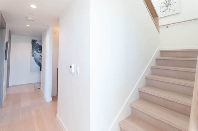 Spacious penthouse entryway with light wood stairs and modern decor. - 2818  - 89 Nelson Street, Vancouver Downtown