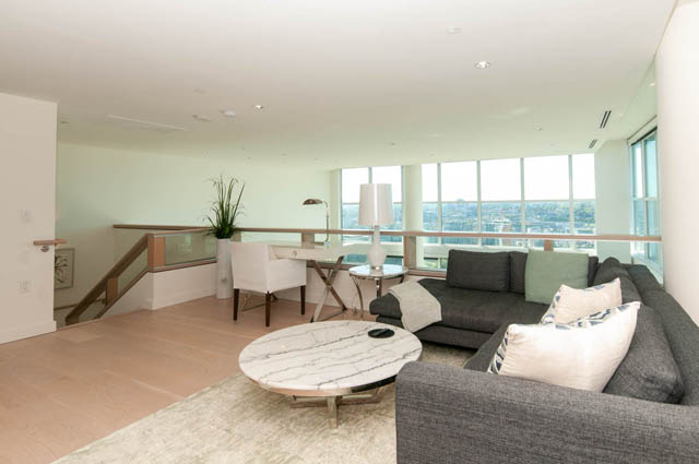 Spacious penthouse living room with hardwood floors, a marble coffee table, and a stunning city view. - 2818  - 89 Nelson Street, Vancouver Downtown