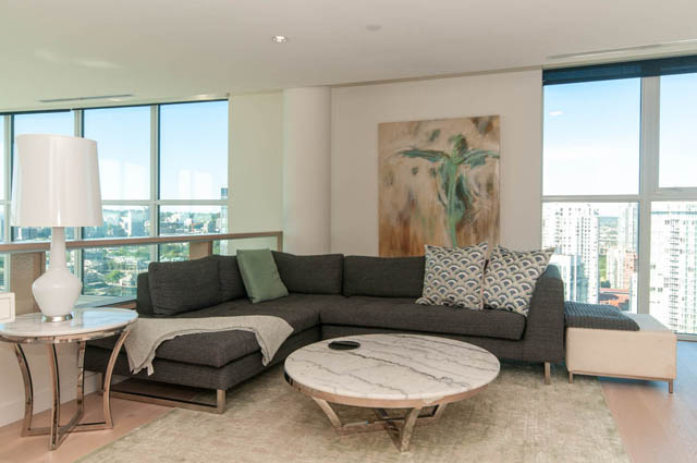 Spacious living room with a large sectional sofa, marble coffee table, and panoramic city view. - 2818  - 89 Nelson Street, Vancouver Downtown