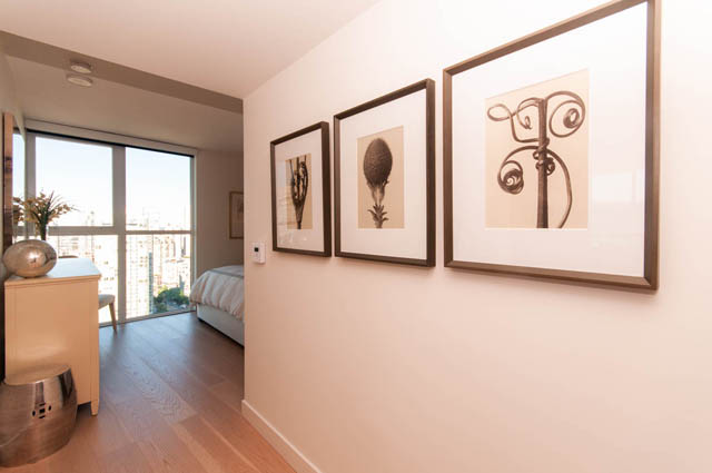 Spacious penthouse bedroom with hardwood floors, city view, and modern artwork. - 2818  - 89 Nelson Street, Vancouver Downtown